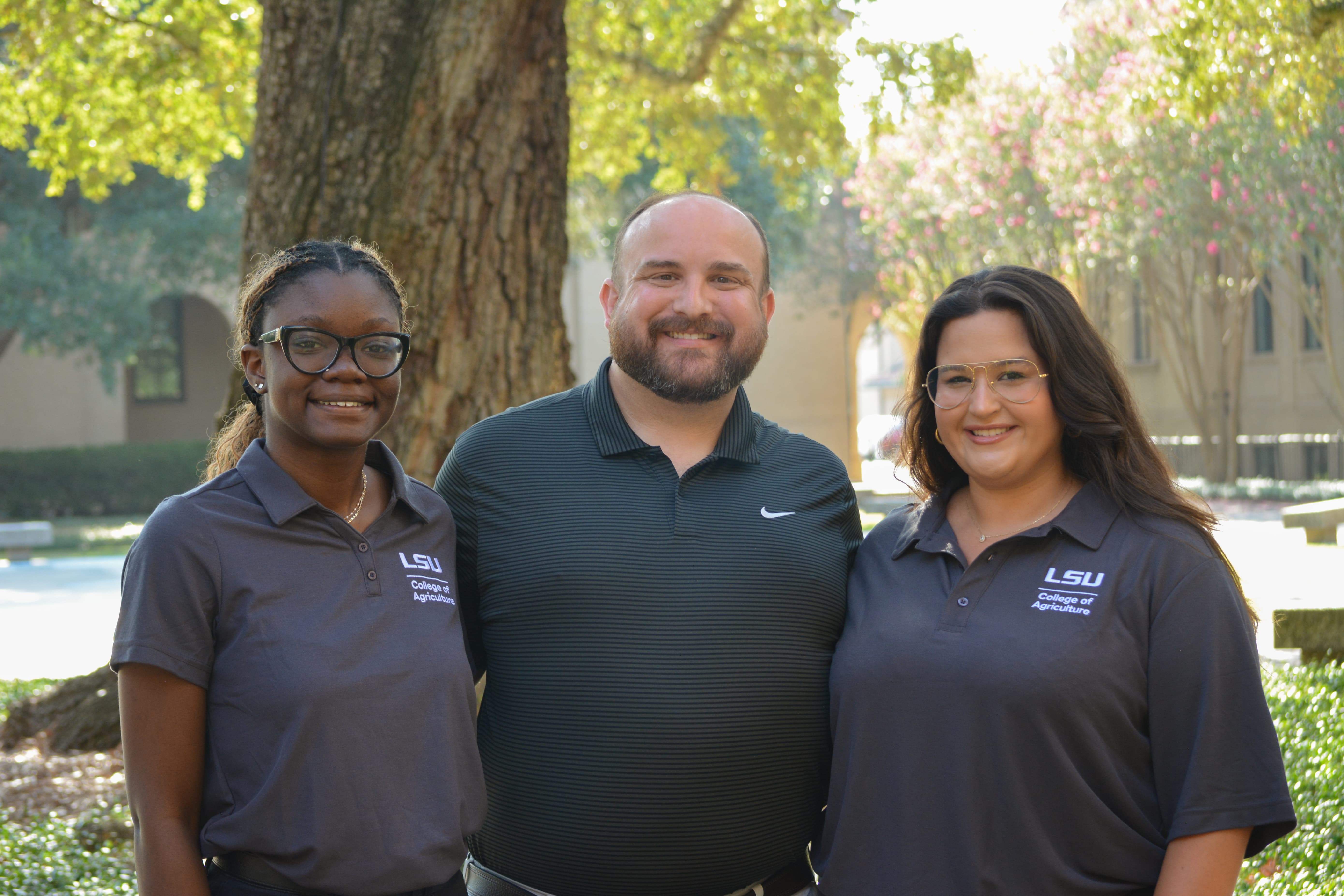 Henry Hebert stands with peer mentors Allie Hubbard and Darlene Hermonstine