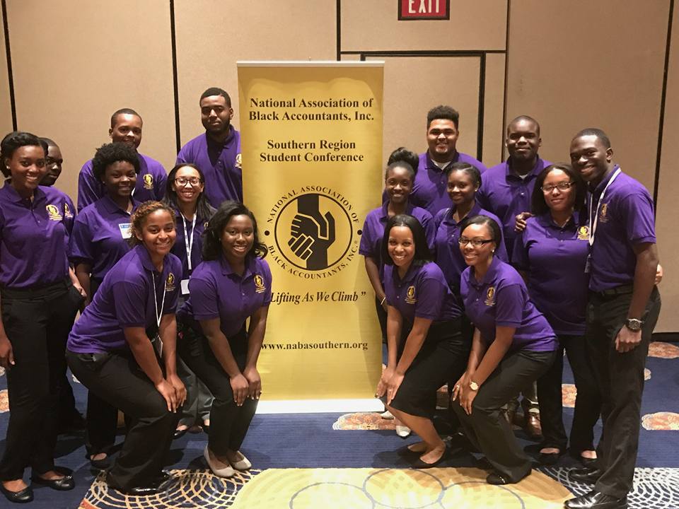 NABA members pose with NABA national banner at a convention. 