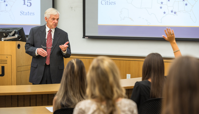 Professor Glenn Sumners lectures in the classroom.