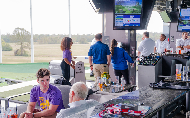 students and sponsors network at Top Golf