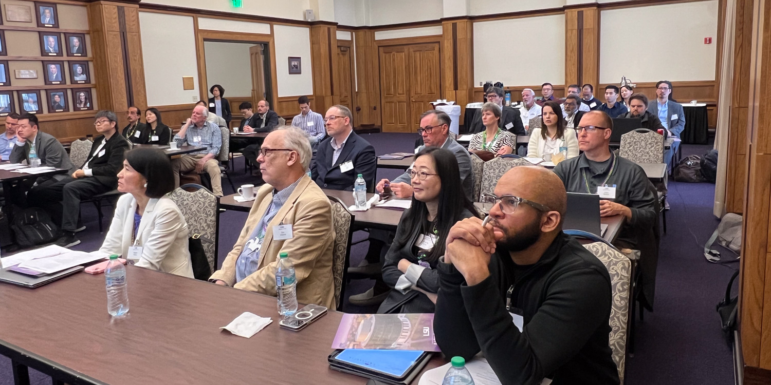 A group of attendees listening intently to a speaker