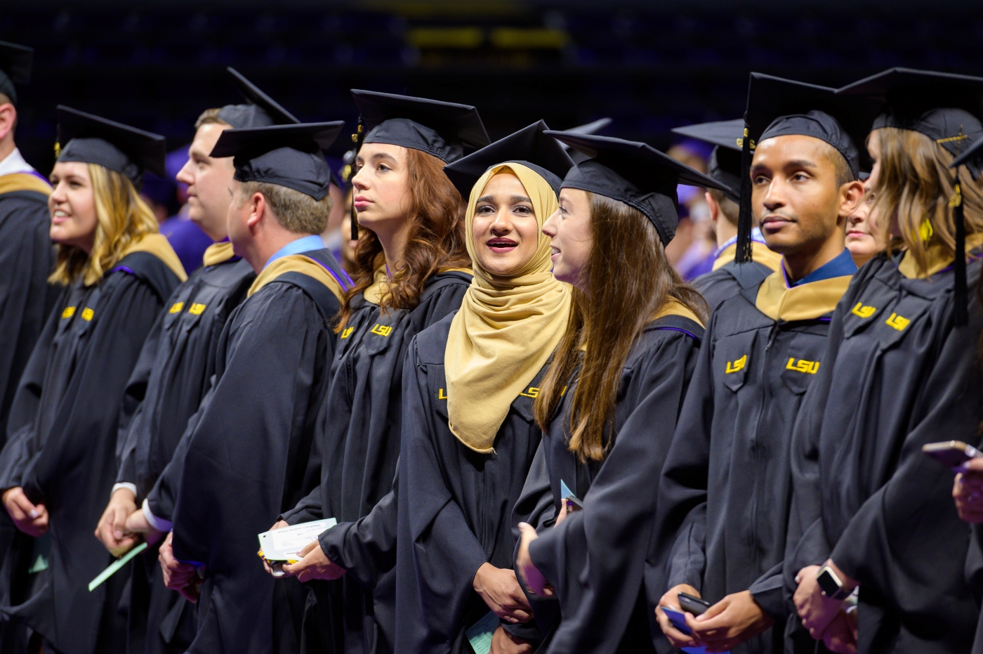 Line of students in caps and gowns at graduation