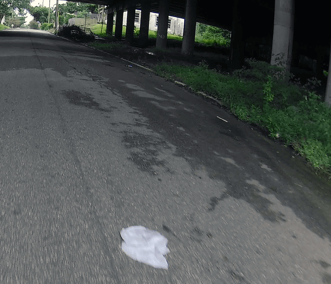 A picture of a plastic bag in the road.