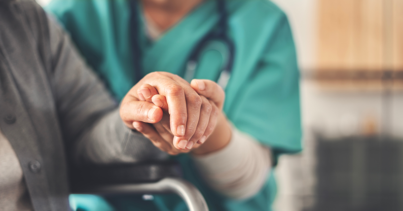 photo of a medical professional helping an older person