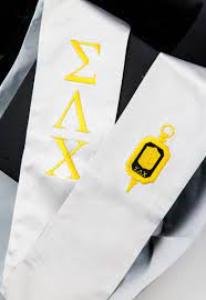 White stole with gold greek letters representing Sigma Lambda Chi.