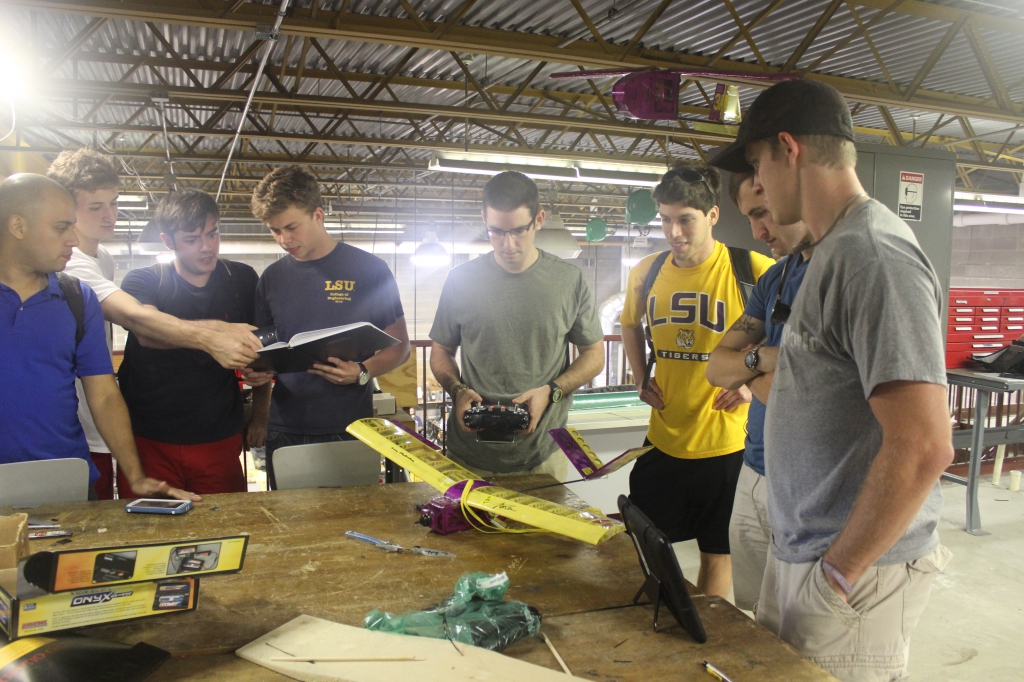 group of students around model plane