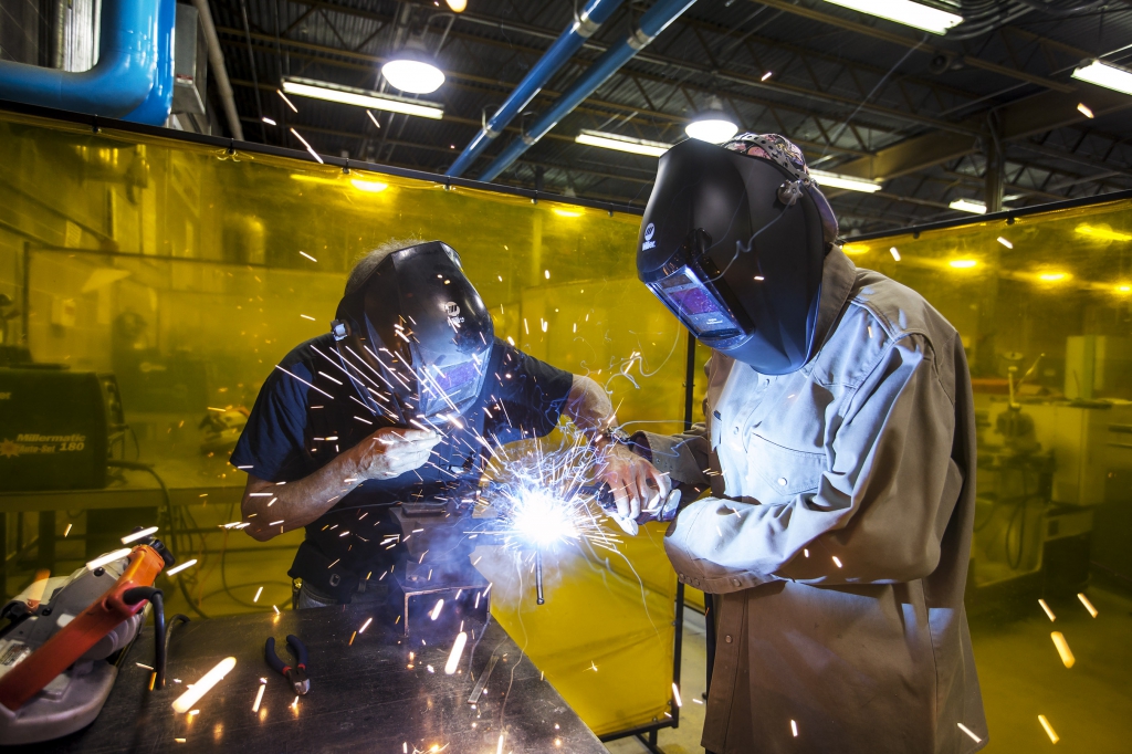 two ie students welding