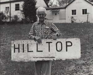 emory with hilltop sign