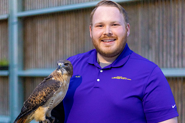 Alec Filson with red-tailed hawk